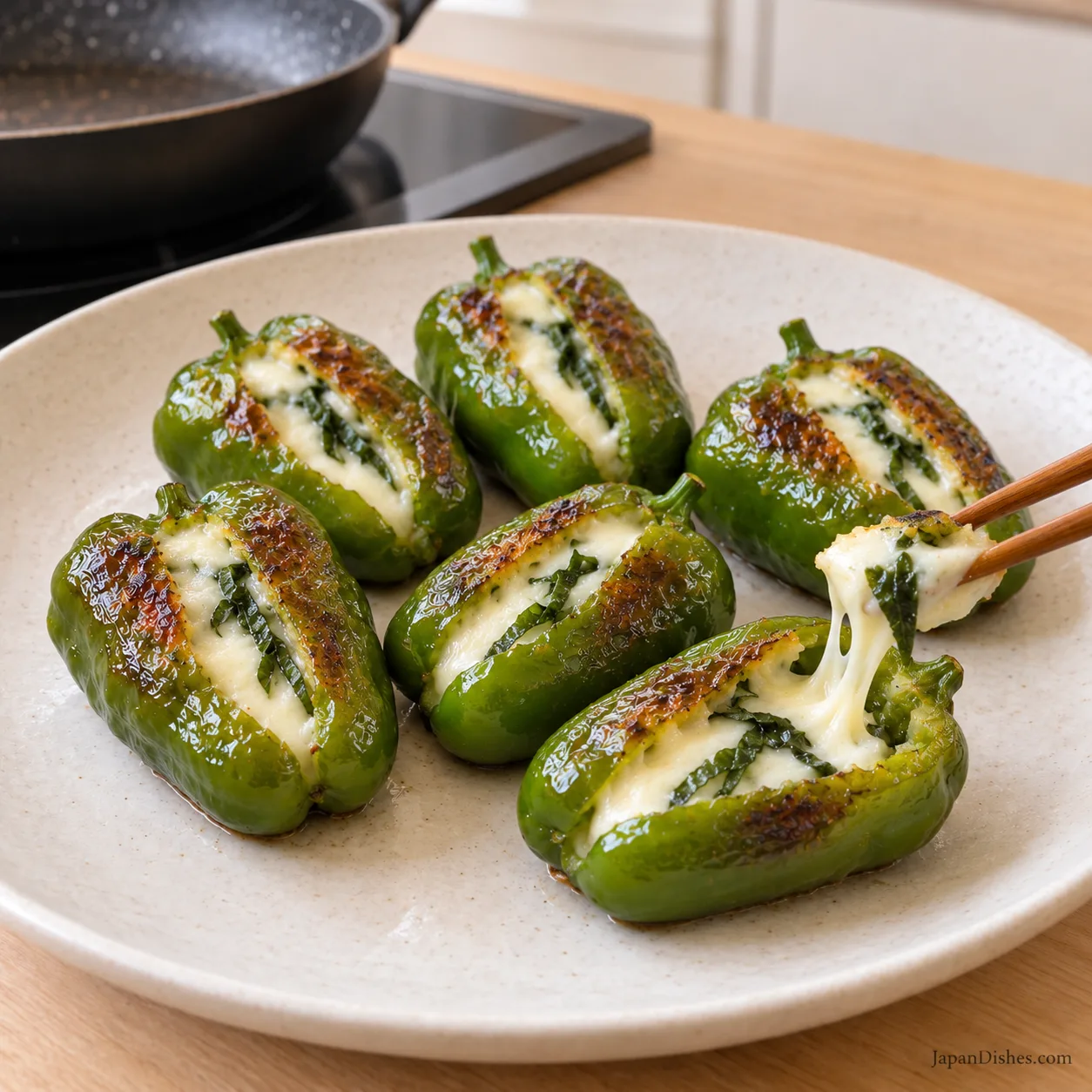 One cooked piman opened to show melted mozzarella and green shiso