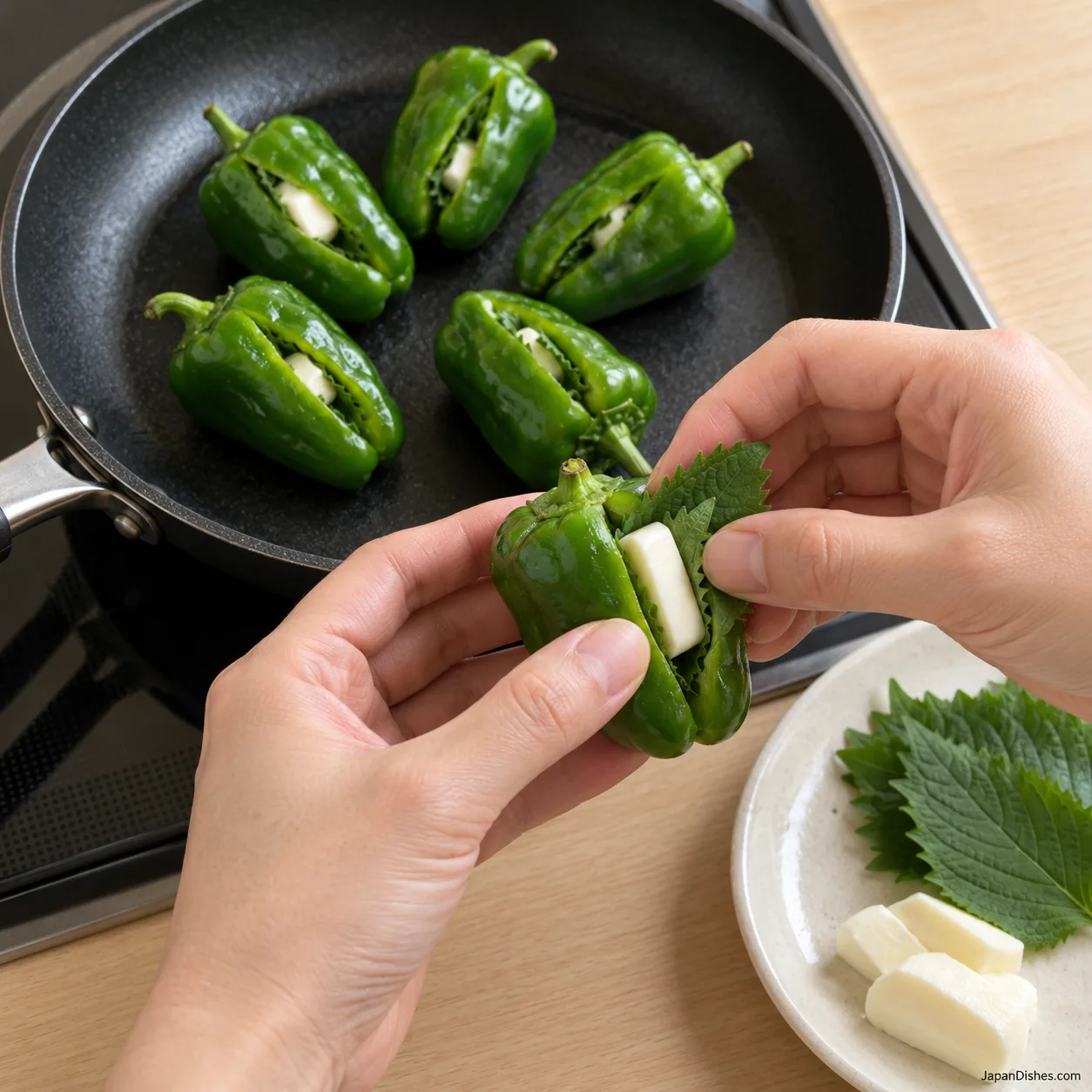 Shiso and mozzarella being tucked inside one whole green pepper