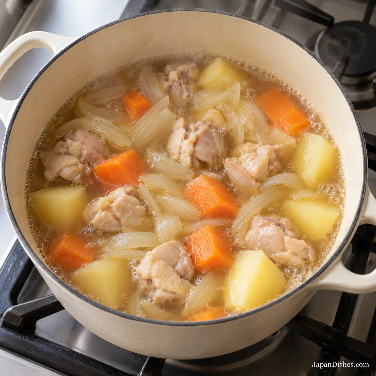 Chicken, carrots, potatoes and onions simmering in light stock before adding curry roux