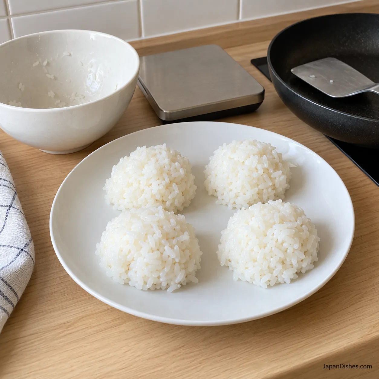 Four equal portions of cooked rice before shaping