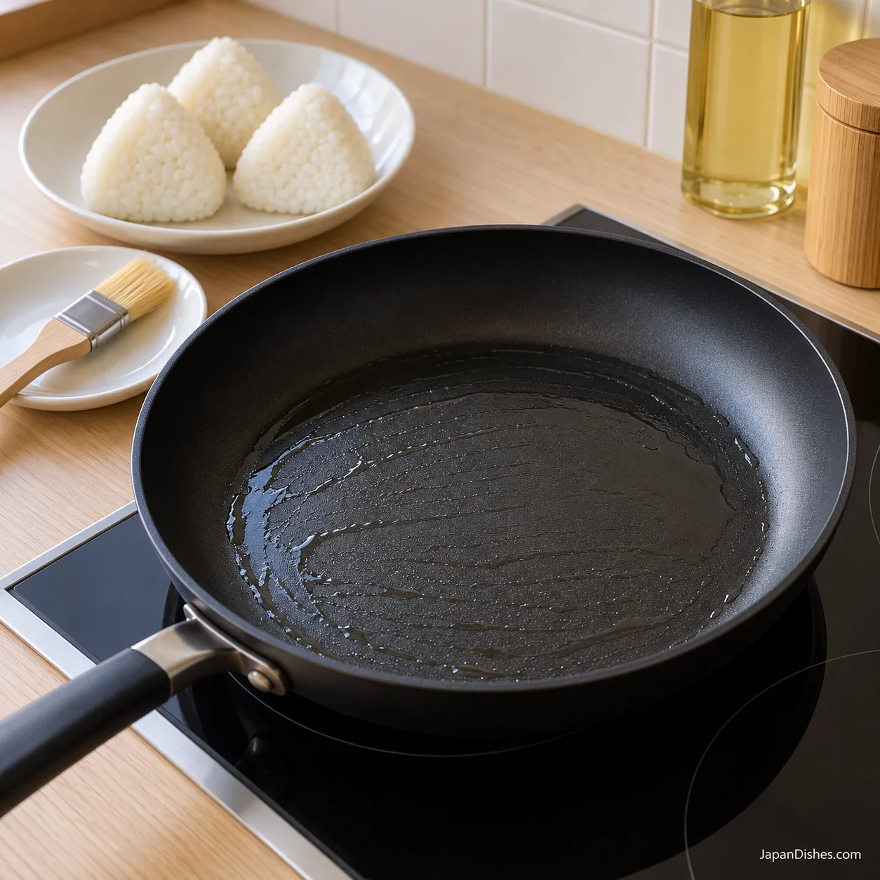 Thin sheen of neutral oil in a black frying pan