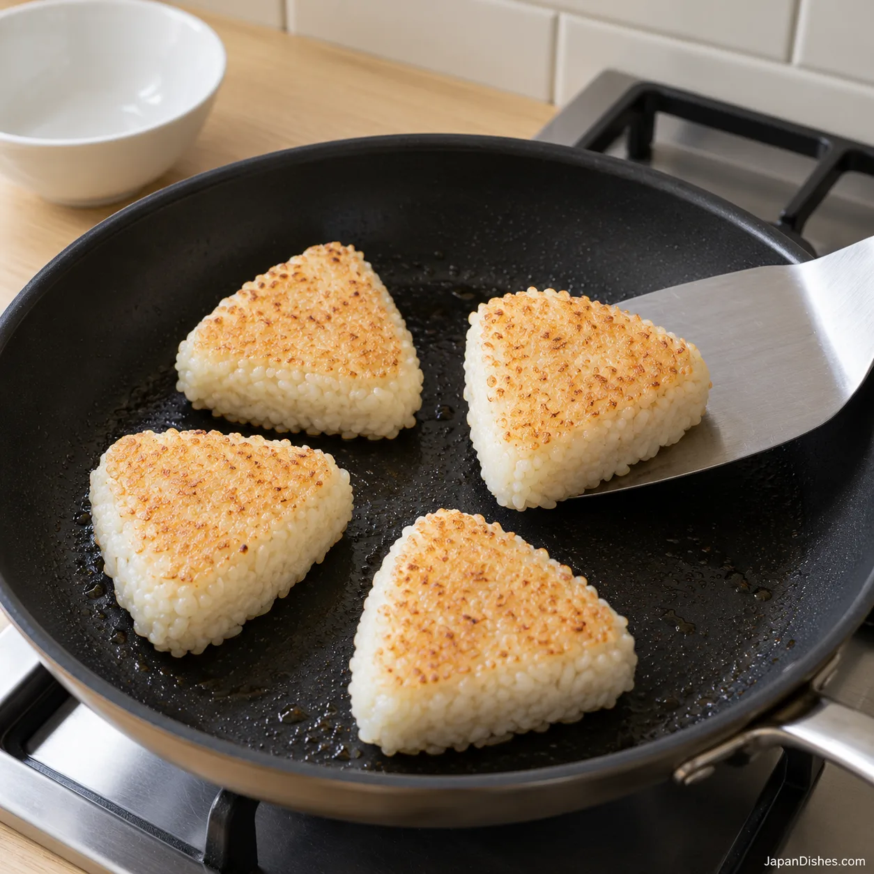 Golden rice crust facing upward after turning the onigiri